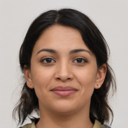 Joyful latino young-adult female with medium  brown hair and brown eyes