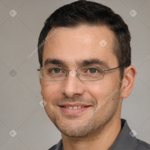 Joyful white adult male with short  black hair and brown eyes