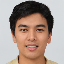 Joyful asian young-adult male with short  black hair and brown eyes