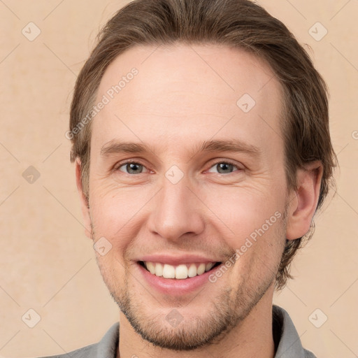 Joyful white adult male with short  brown hair and grey eyes