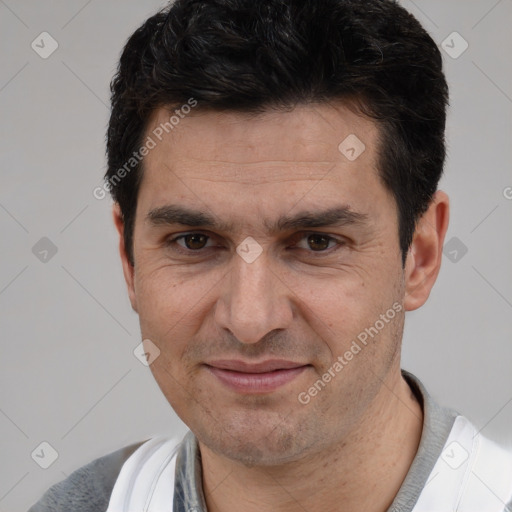 Joyful white adult male with short  black hair and brown eyes