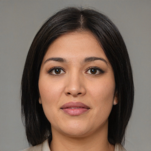 Joyful latino young-adult female with medium  brown hair and brown eyes