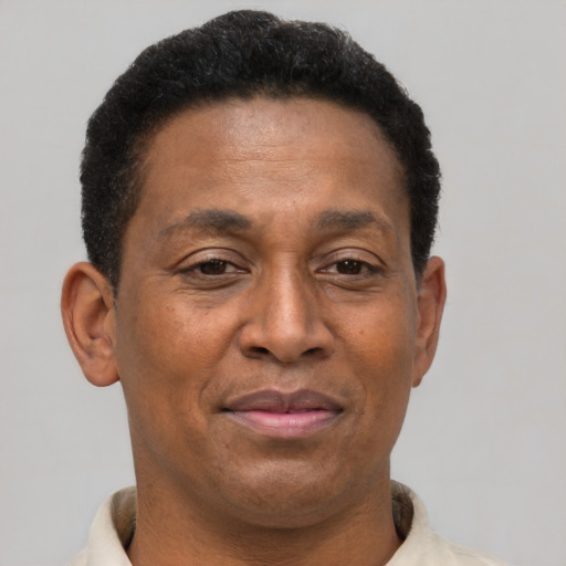 Joyful black adult male with short  brown hair and brown eyes