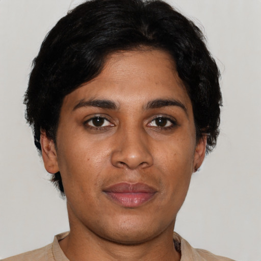 Joyful latino young-adult female with short  black hair and brown eyes