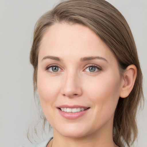 Joyful white young-adult female with medium  brown hair and grey eyes