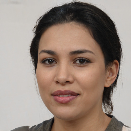 Joyful latino young-adult female with medium  brown hair and brown eyes