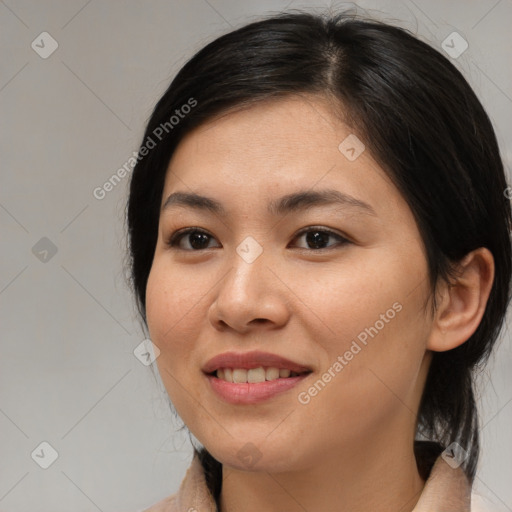 Joyful asian young-adult female with medium  brown hair and brown eyes