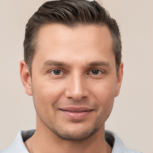 Joyful white young-adult male with short  brown hair and brown eyes