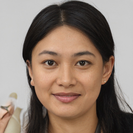 Joyful asian young-adult female with long  brown hair and brown eyes