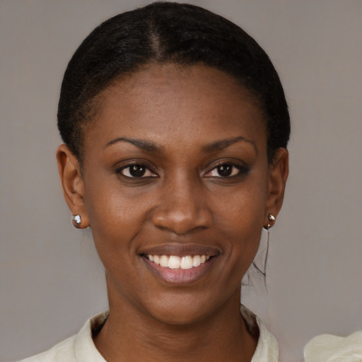 Joyful black young-adult female with short  brown hair and brown eyes