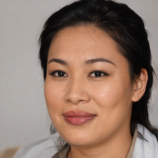 Joyful asian young-adult female with medium  black hair and brown eyes