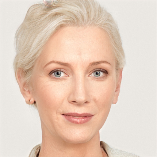 Joyful white adult female with short  blond hair and blue eyes