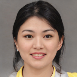 Joyful asian young-adult female with medium  brown hair and brown eyes