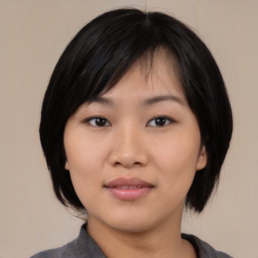 Joyful asian young-adult female with medium  black hair and brown eyes