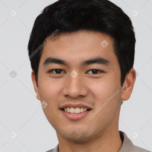 Joyful asian young-adult male with short  black hair and brown eyes