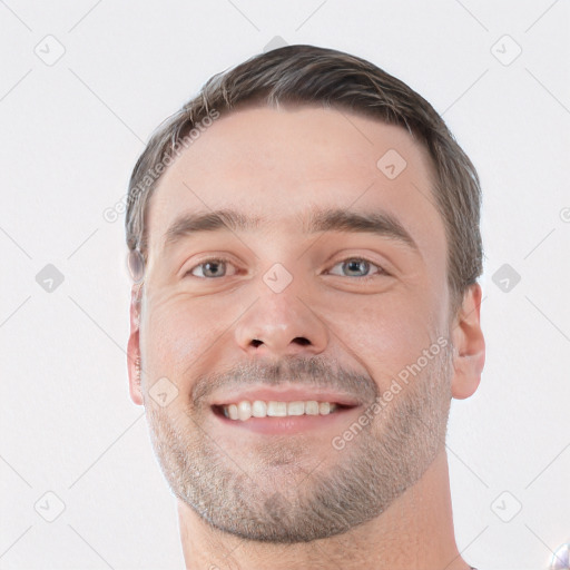 Joyful white young-adult male with short  brown hair and grey eyes