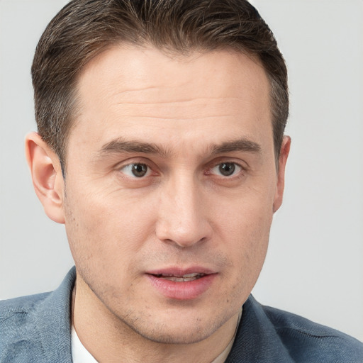 Joyful white adult male with short  brown hair and grey eyes