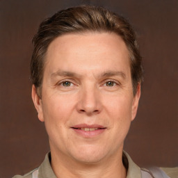 Joyful white adult male with short  brown hair and grey eyes