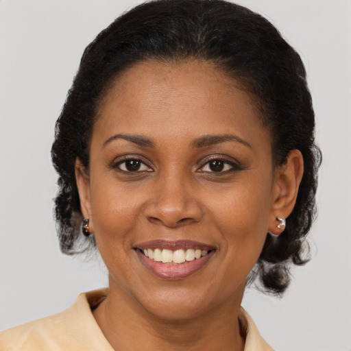 Joyful black young-adult female with medium  brown hair and brown eyes