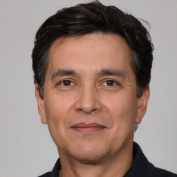 Joyful white adult male with short  black hair and brown eyes