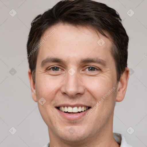 Joyful white adult male with short  brown hair and brown eyes