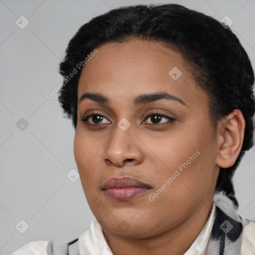 Joyful black young-adult female with short  black hair and brown eyes