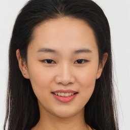 Joyful asian young-adult female with long  brown hair and brown eyes