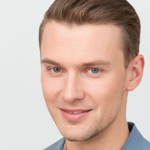 Joyful white young-adult male with short  brown hair and grey eyes