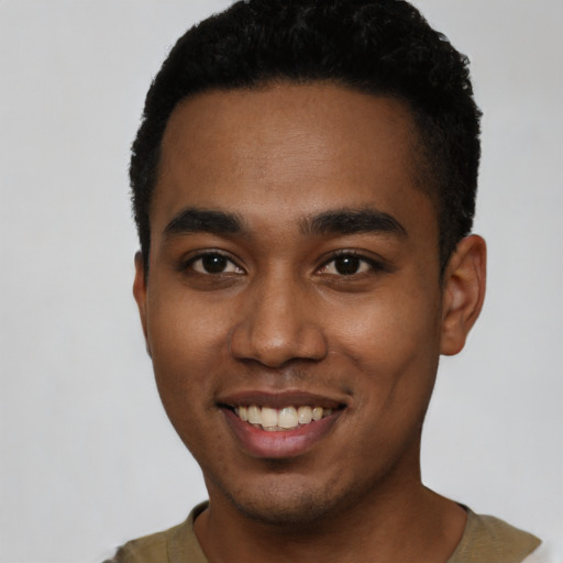 Joyful black young-adult male with short  black hair and brown eyes