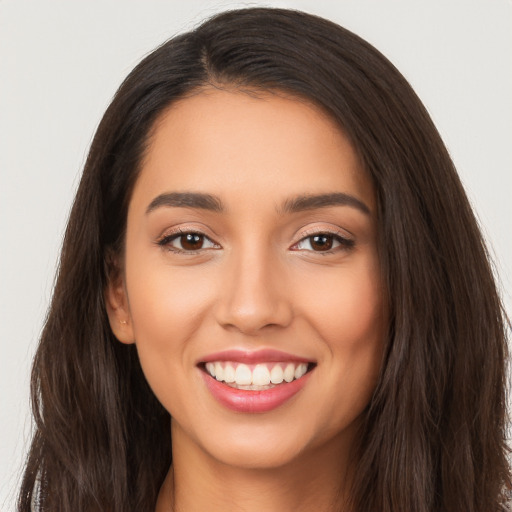 Joyful white young-adult female with long  brown hair and brown eyes