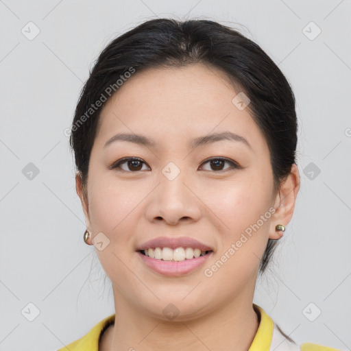 Joyful asian young-adult female with short  brown hair and brown eyes