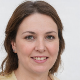 Joyful white adult female with medium  brown hair and grey eyes