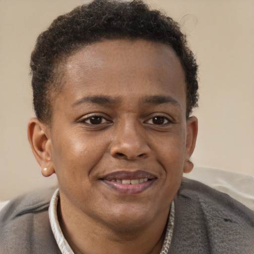 Joyful black young-adult male with short  brown hair and brown eyes