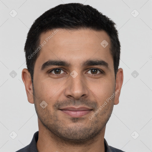 Joyful latino young-adult male with short  black hair and brown eyes