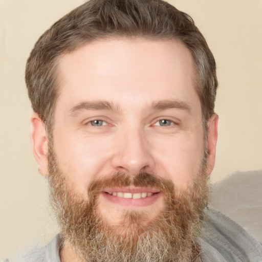 Joyful white adult male with short  brown hair and brown eyes