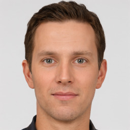 Joyful white young-adult male with short  brown hair and grey eyes