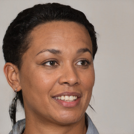 Joyful latino adult female with short  brown hair and brown eyes