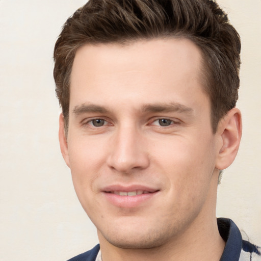 Joyful white young-adult male with short  brown hair and brown eyes