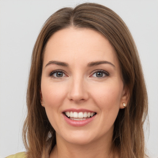 Joyful white young-adult female with medium  brown hair and green eyes