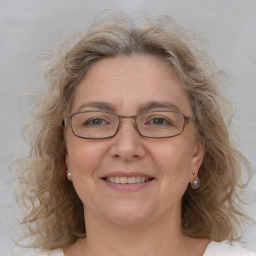 Joyful white adult female with medium  brown hair and blue eyes