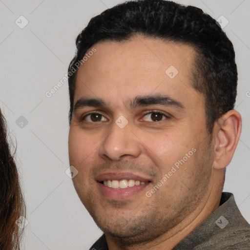 Joyful white young-adult male with short  black hair and brown eyes