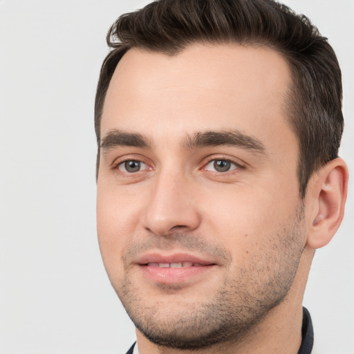 Joyful white young-adult male with short  brown hair and brown eyes