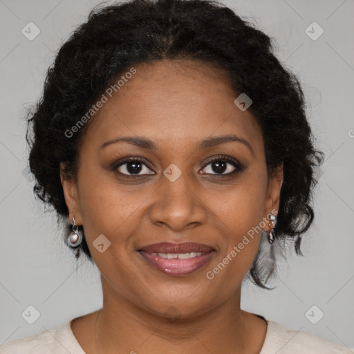 Joyful black adult female with medium  brown hair and brown eyes