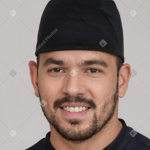 Joyful white young-adult male with short  black hair and brown eyes