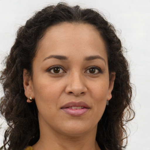 Joyful white adult female with long  brown hair and brown eyes