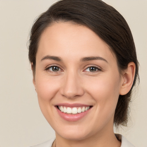 Joyful white young-adult female with medium  brown hair and brown eyes