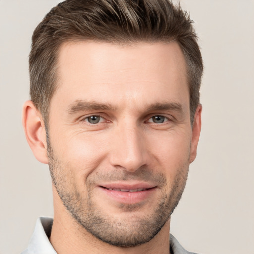 Joyful white young-adult male with short  brown hair and brown eyes