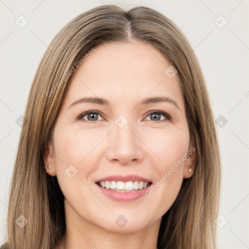 Joyful white young-adult female with long  brown hair and brown eyes