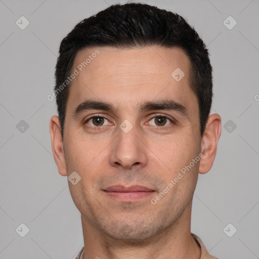 Joyful white young-adult male with short  black hair and brown eyes