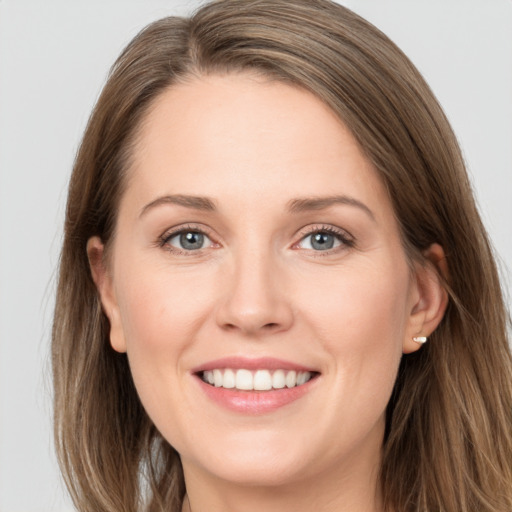 Joyful white young-adult female with long  brown hair and grey eyes